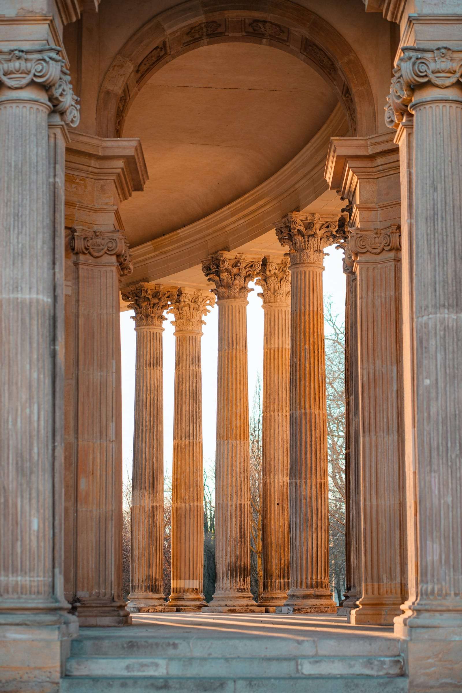 Stone columns of a rotunda in low sunset light