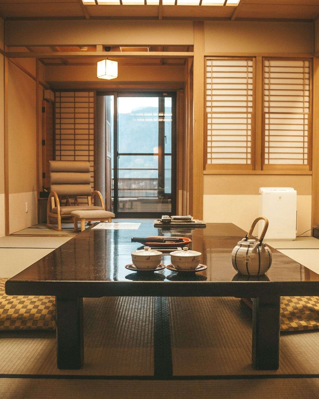 A tatami room with a low lacquered table set for tea