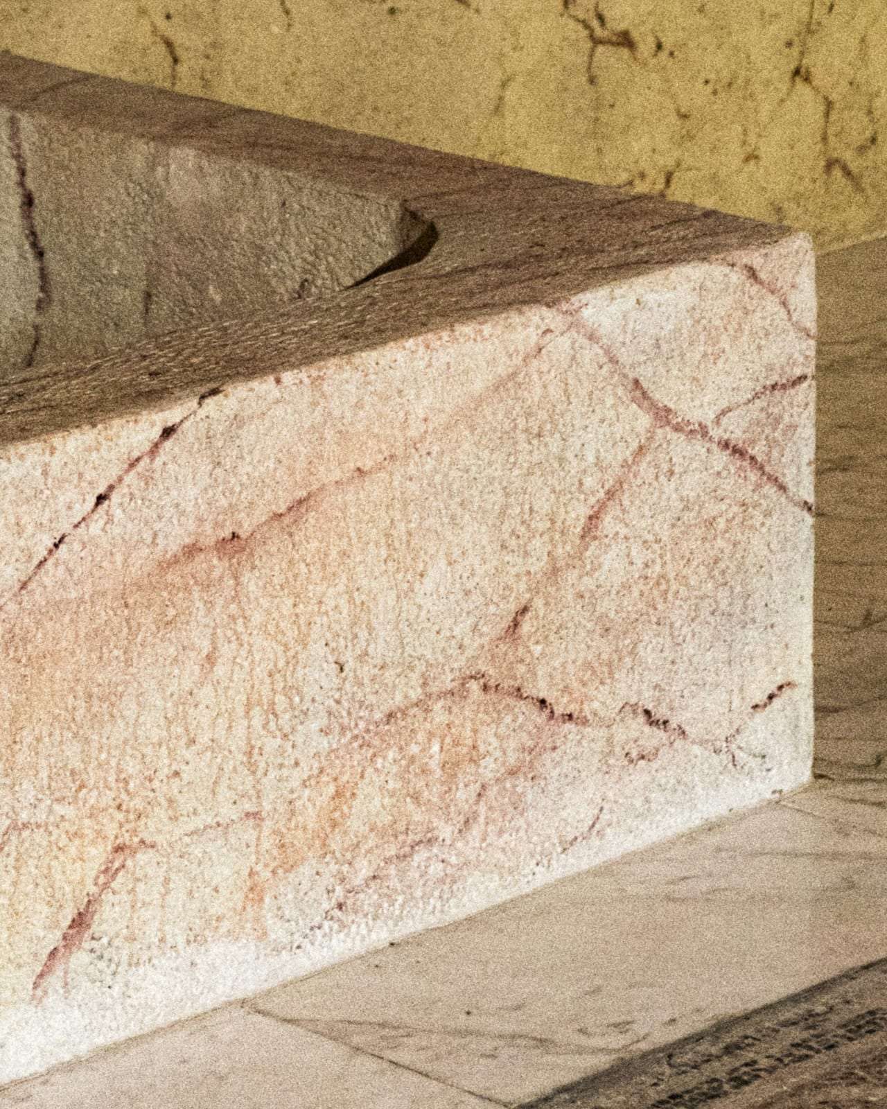 A marble bath set against stone walls